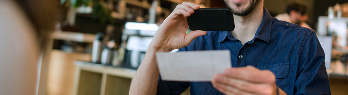 Man making remote deposit in a restaurant