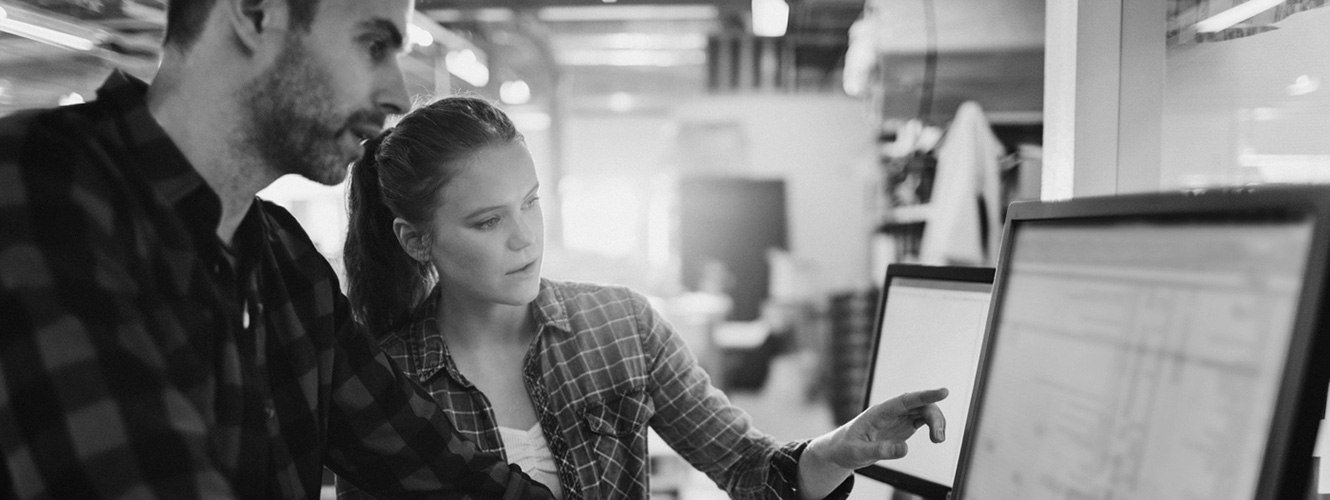 Man and woman employees at a computer